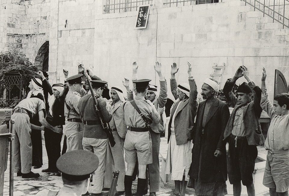 35-British-policemen-frisking-Palestinians-1936