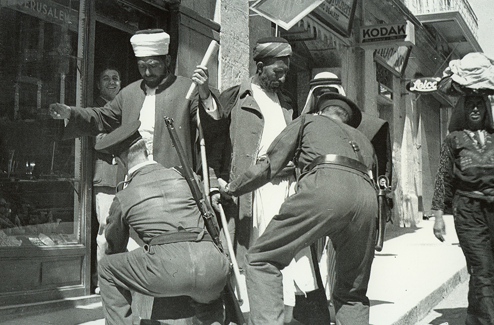 36-British-policemen-frisking-Palestinians-1936